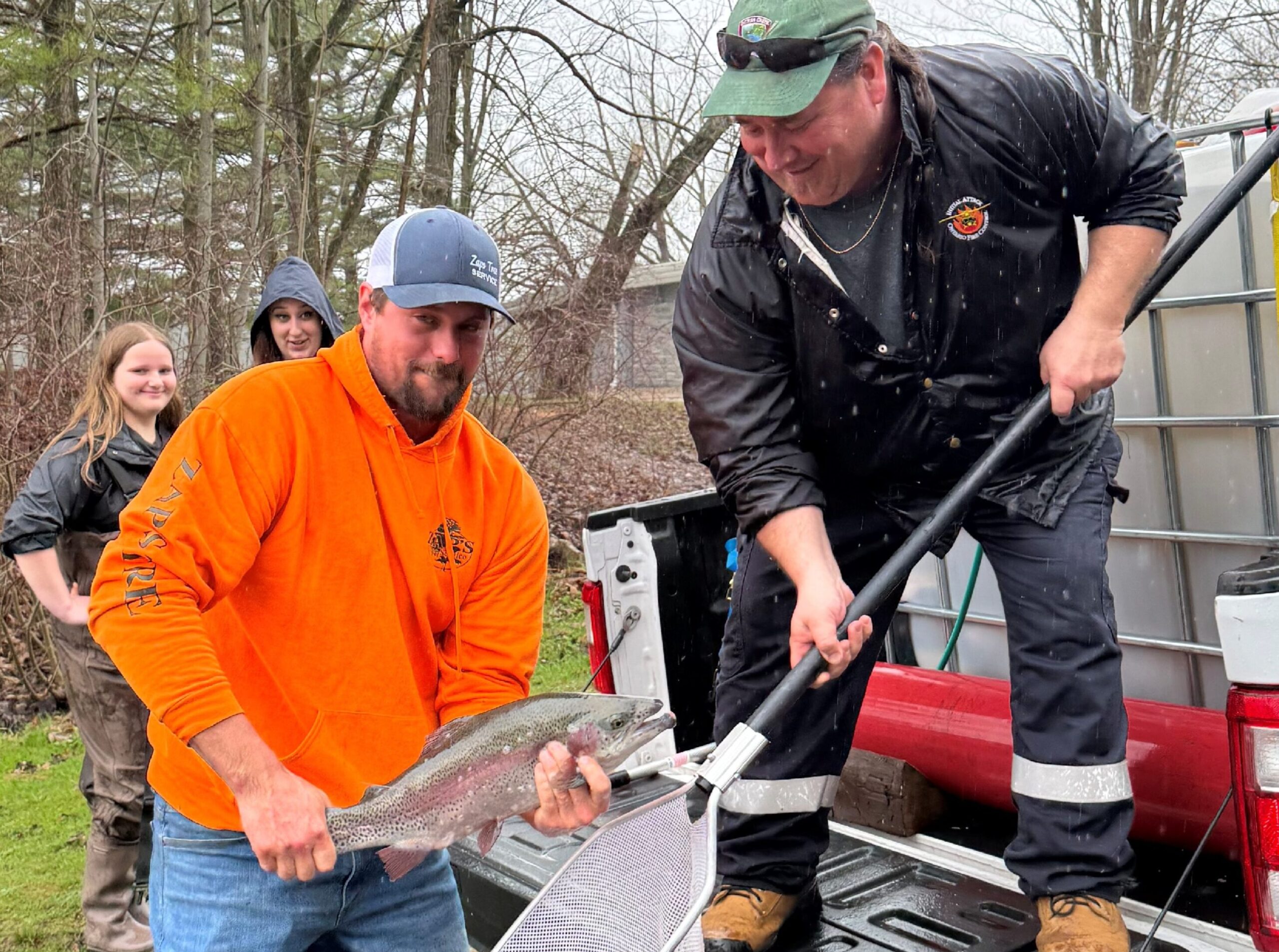 two men showing off a fish they caught in Aylmer Ontario. Photo taken by Aylmer Express